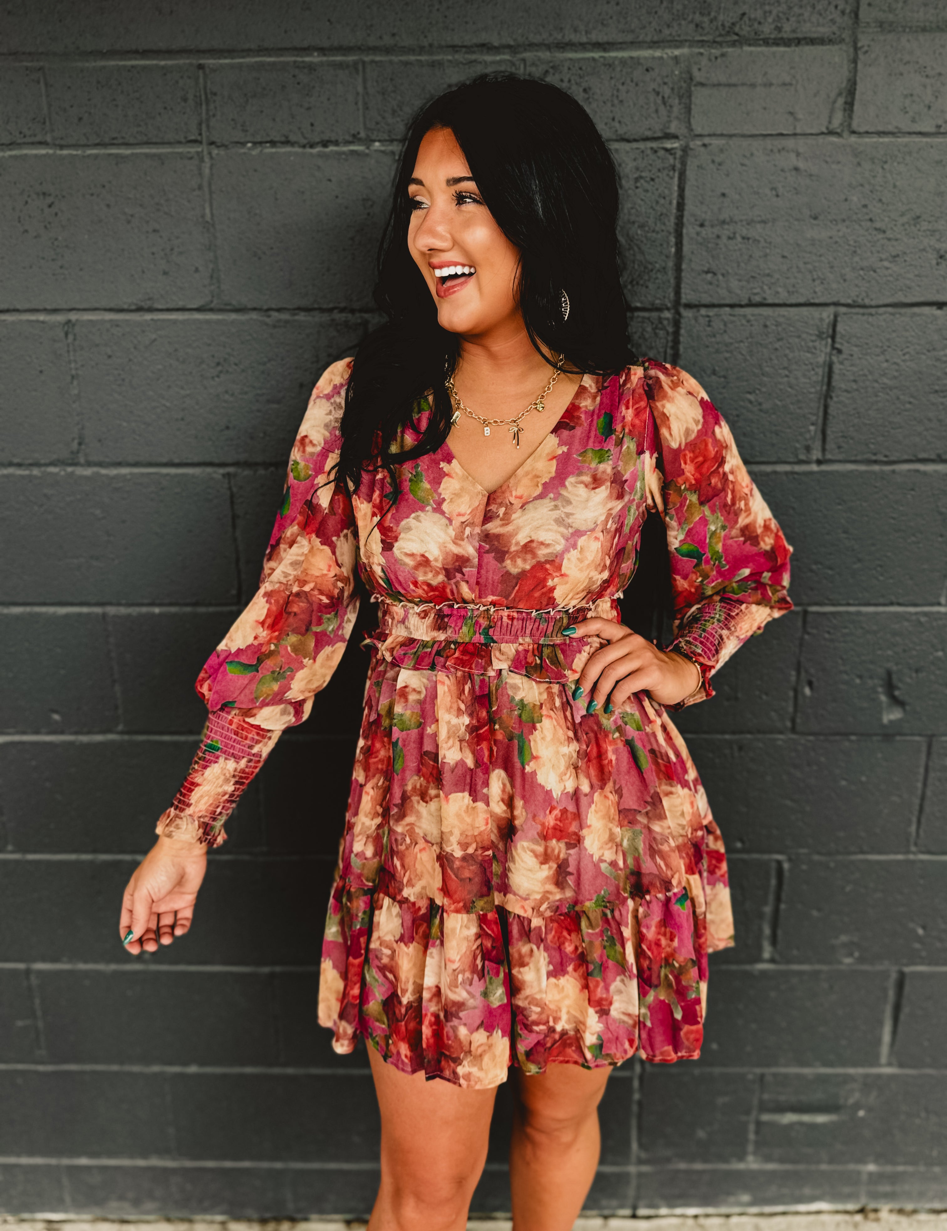 Long sleeved floral ruffle mini dress with an elastic waistband.