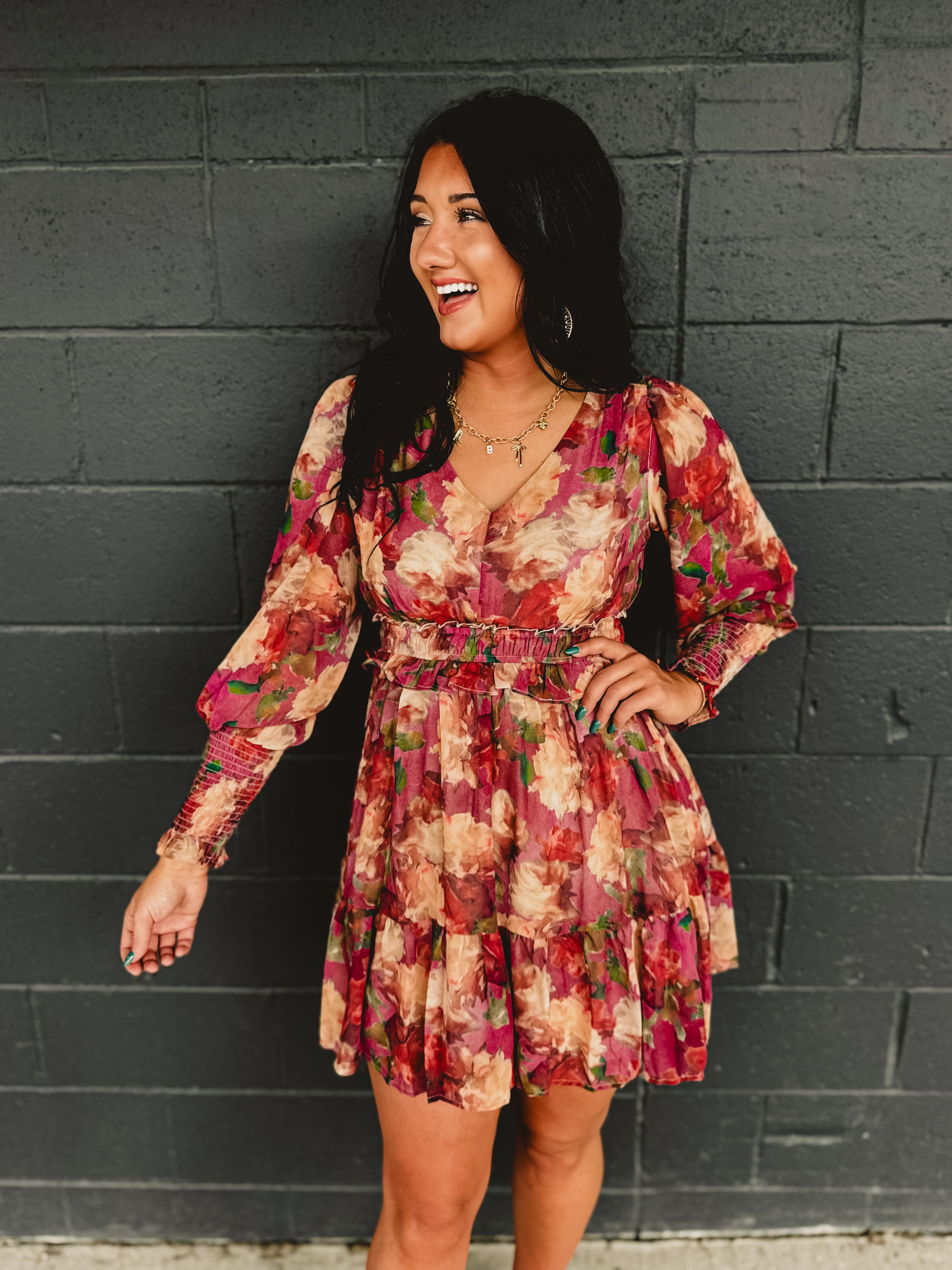 Long sleeved floral ruffle mini dress with an elastic waistband.