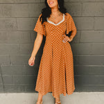Sweetheart neckline short sleeved midi dress with back tie detail, polka dots, and hidden side pockets in the color Sepia(Camel).