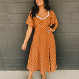 Sweetheart neckline short sleeved midi dress with back tie detail, polka dots, and hidden side pockets in the color Sepia(Camel).