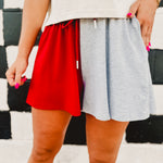 Colorblock french terry drawstring flowy shorts in red and gray.