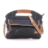 BedStu Greenway crossbody bag in black leather with oats rustic trim, showing the front pocket and adjustable crossbody strap