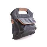 Angled view of the black Greenway showing the cutout top handle and magnetic flap front pocket