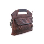 Angled view of the teak Greenway showing the cutout top handle and magnetic flap front pocket