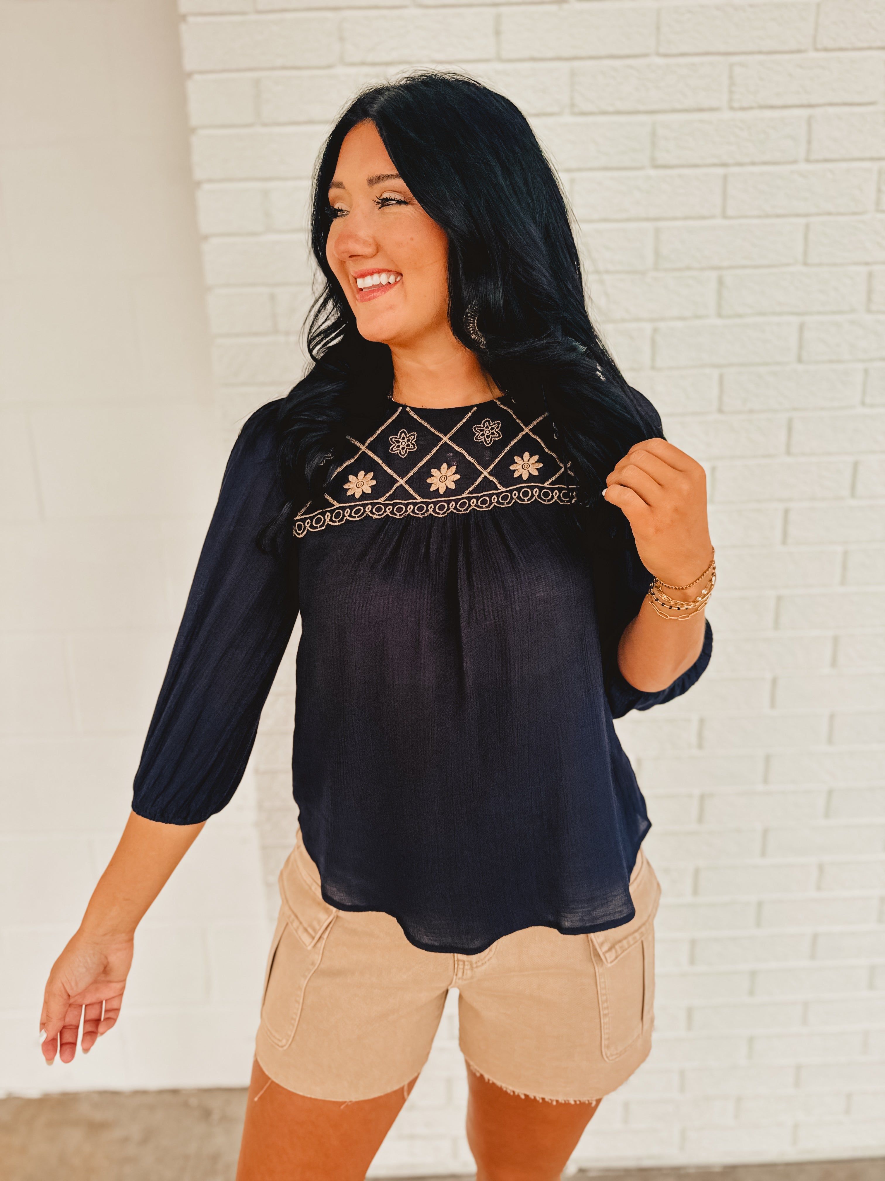 Half sleeve navy and beige blouse with embroidery and a boat neck.