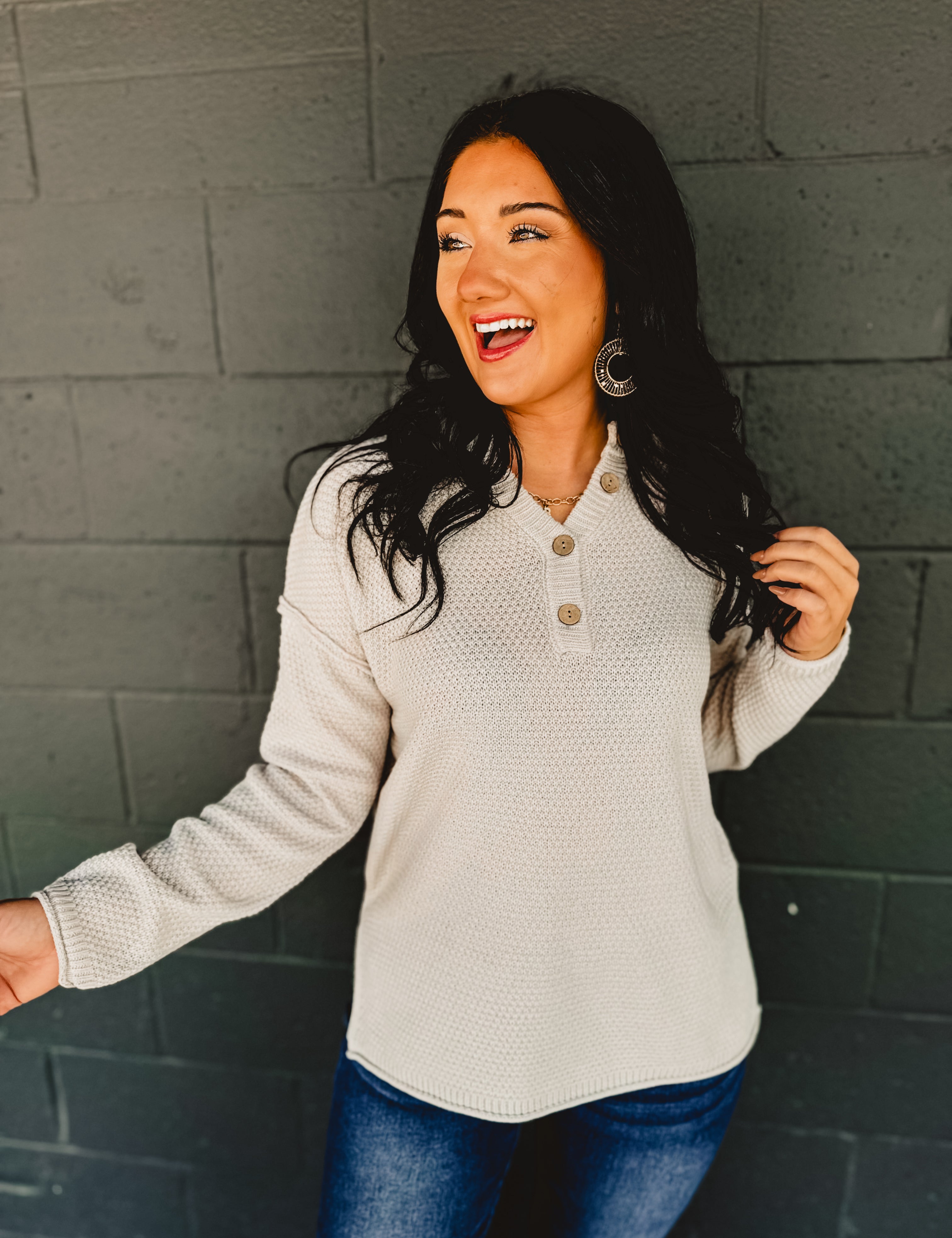 Henley neckline waffle knit long sleeve top in the color bone.
