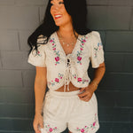 Woman wearing a white embroidered outfit