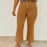 Straight cropped deep camel colored jeans with raw frayed hems.