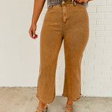 Straight cropped deep camel colored jeans with raw frayed hems.