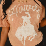 Howdy mineral washed coral colored graphic tee with short sleeves and a round neck.