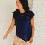 Short ruffle sleeved navy blue cutout detail blouse.