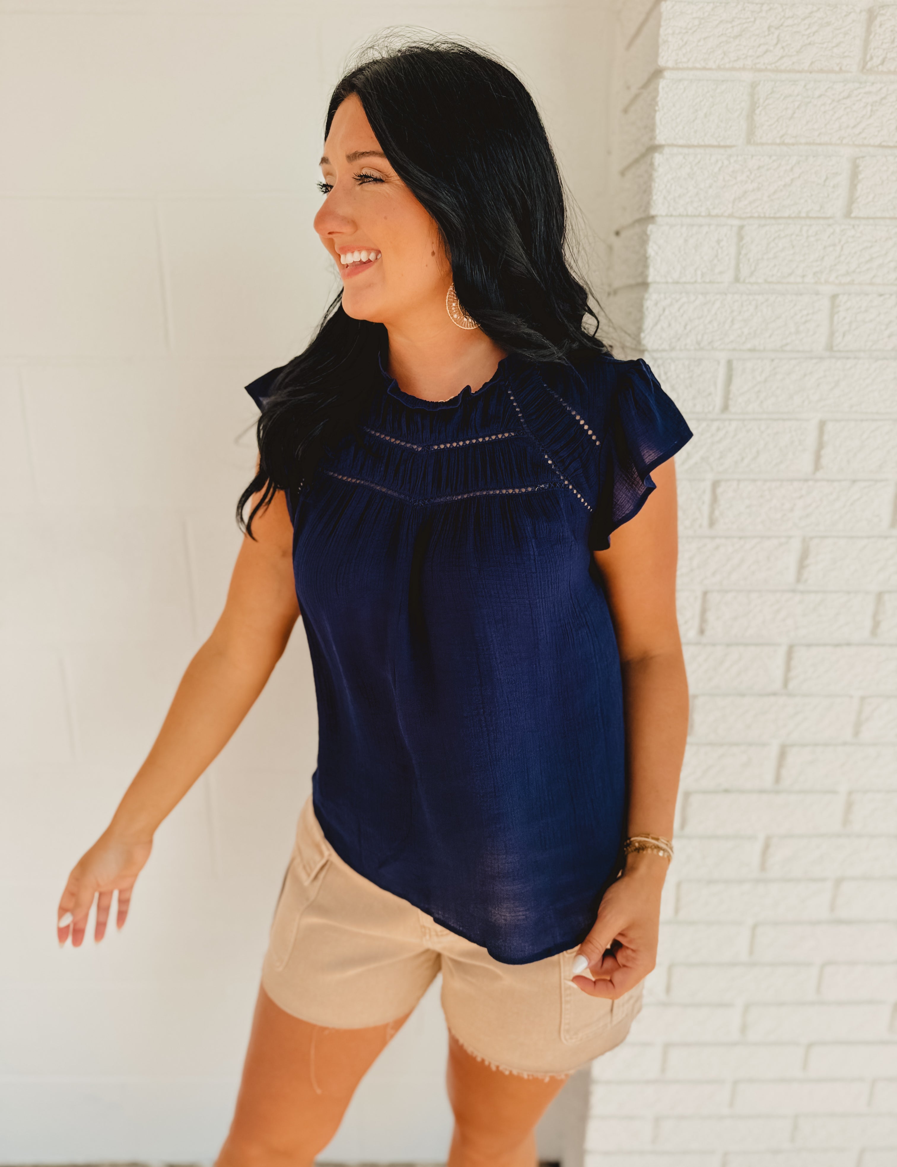 Short ruffle sleeved navy blue cutout detail blouse.