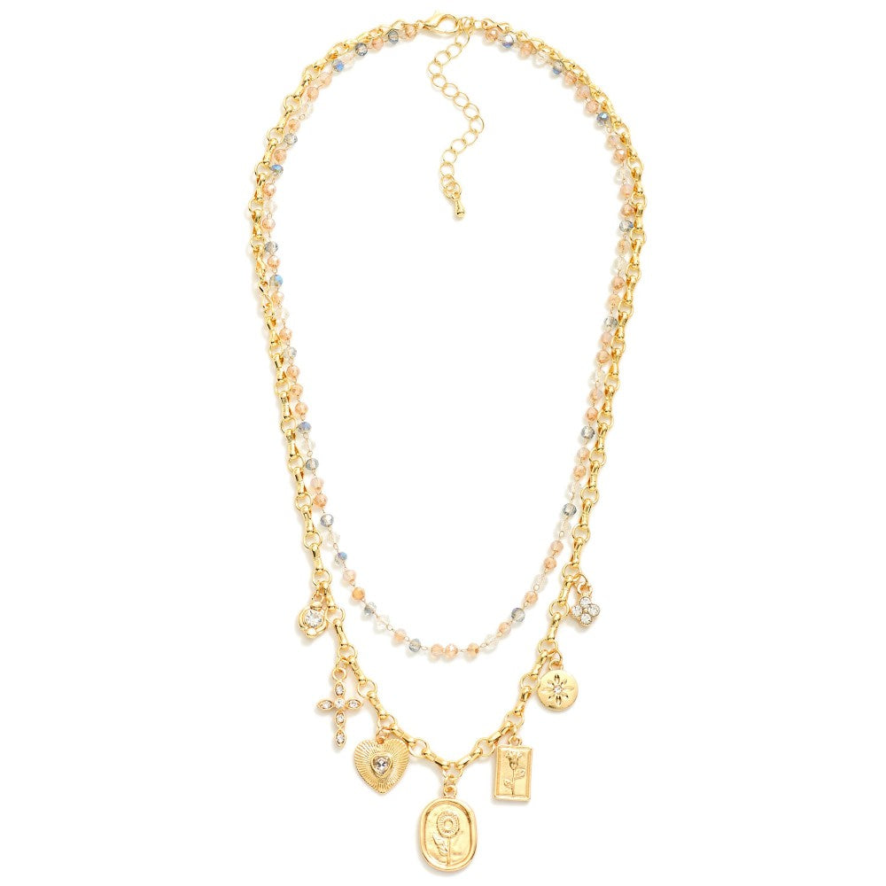 Gold layered necklace with beaded layer in blue hues and a chain link with charms.