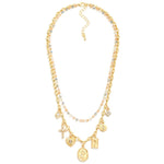 Gold layered necklace with beaded layer in blue hues and a chain link with charms.