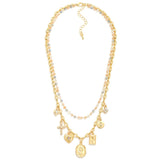 Gold layered necklace with beaded layer in blue hues and a chain link with charms.