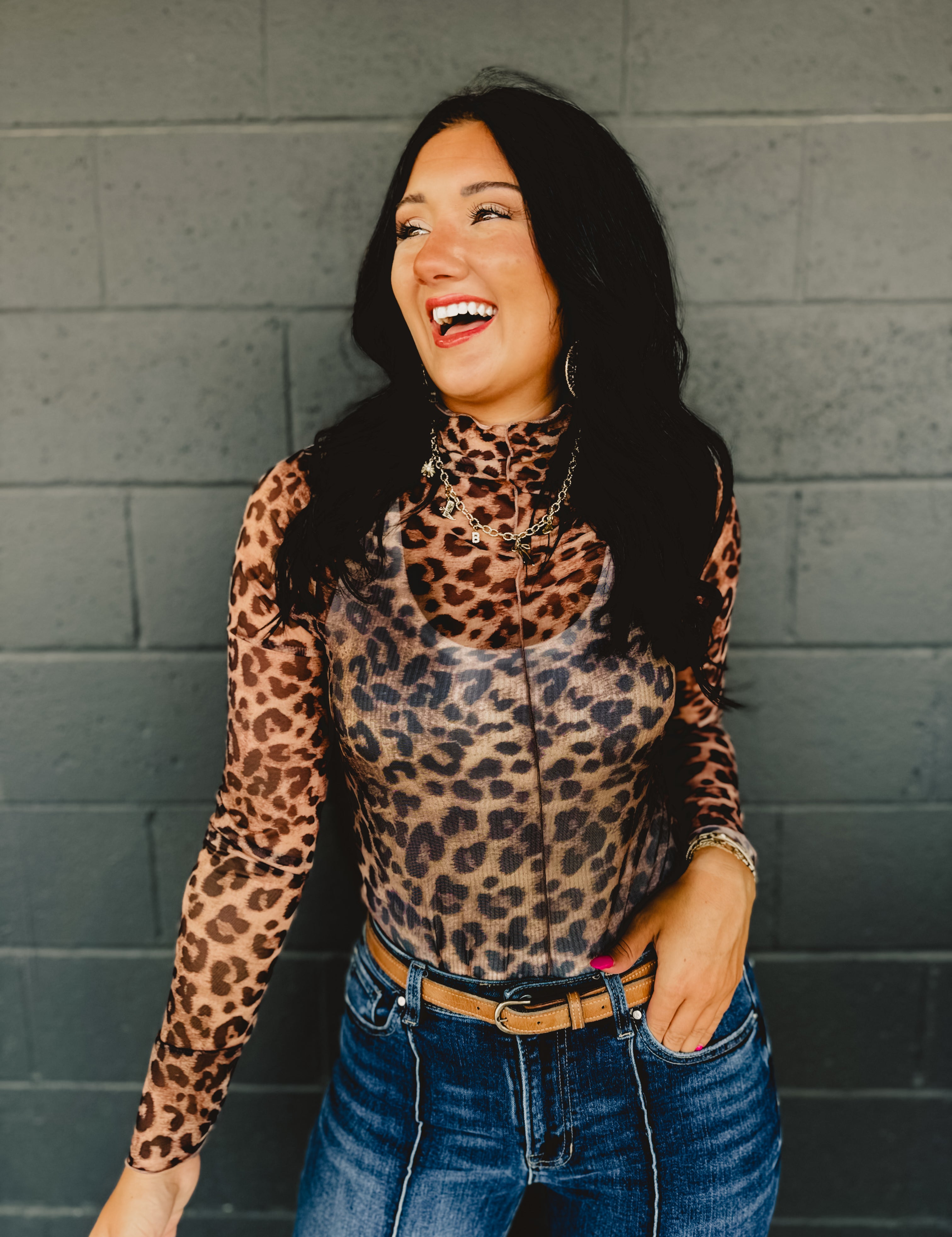 High mock neck long sleeve sheer leopard print top with ruffle hems and a front seam.