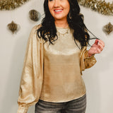 Metallic woven balloon sleeve blouse in gold.