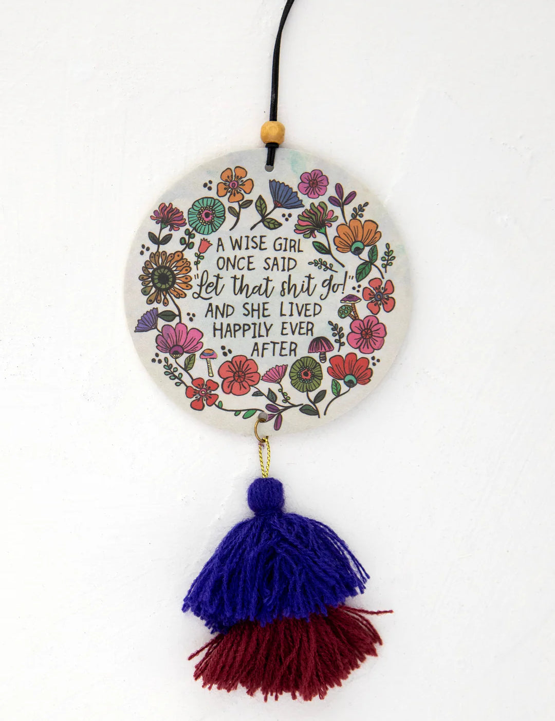 Natural Life car air freshener that reads "A wise girl once said "Let that shit go and she lived happily ever after" with double sided artwork and elastic string for hanging in the scent Ocean.