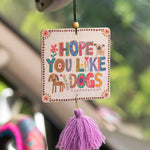 Fruity and floral essential oil scented car air freshener made by Natural Life that reads "Hope You Like Dogs."