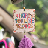 Fruity and floral essential oil scented car air freshener made by Natural Life that reads "Hope You Like Dogs."