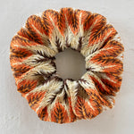 Natural Life burnt orange multi scrunchie ponytail holder.