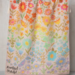 Colorful floral cotton dish towel by Natural Life that reads "thankful, grateful" in the corner.