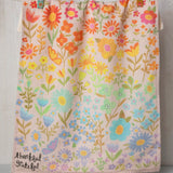 Colorful floral cotton dish towel by Natural Life that reads "thankful, grateful" in the corner.