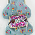 Embroidered kisslock coin purse with graphics by Natural Life in denim.