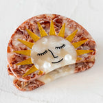 Hair clip with a sun design and pearl accents by Natural Life.