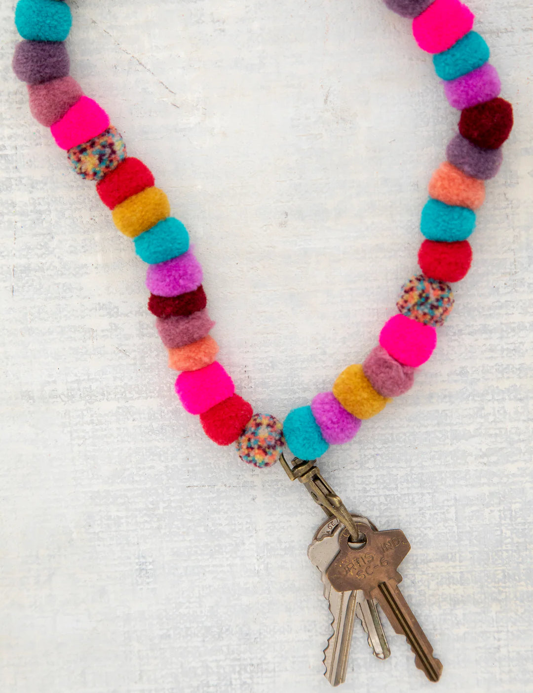 Multicolor Pom Pom lanyard with antique brass clasp by Natural Life.