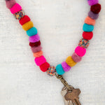 Multicolor Pom Pom lanyard with antique brass clasp by Natural Life.
