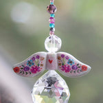 Decorative angel ornament with floral wings and a teardrop-shaped crystal by Natural Life.