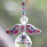 Decorative angel ornament with floral wings and a teardrop-shaped crystal by Natural Life.