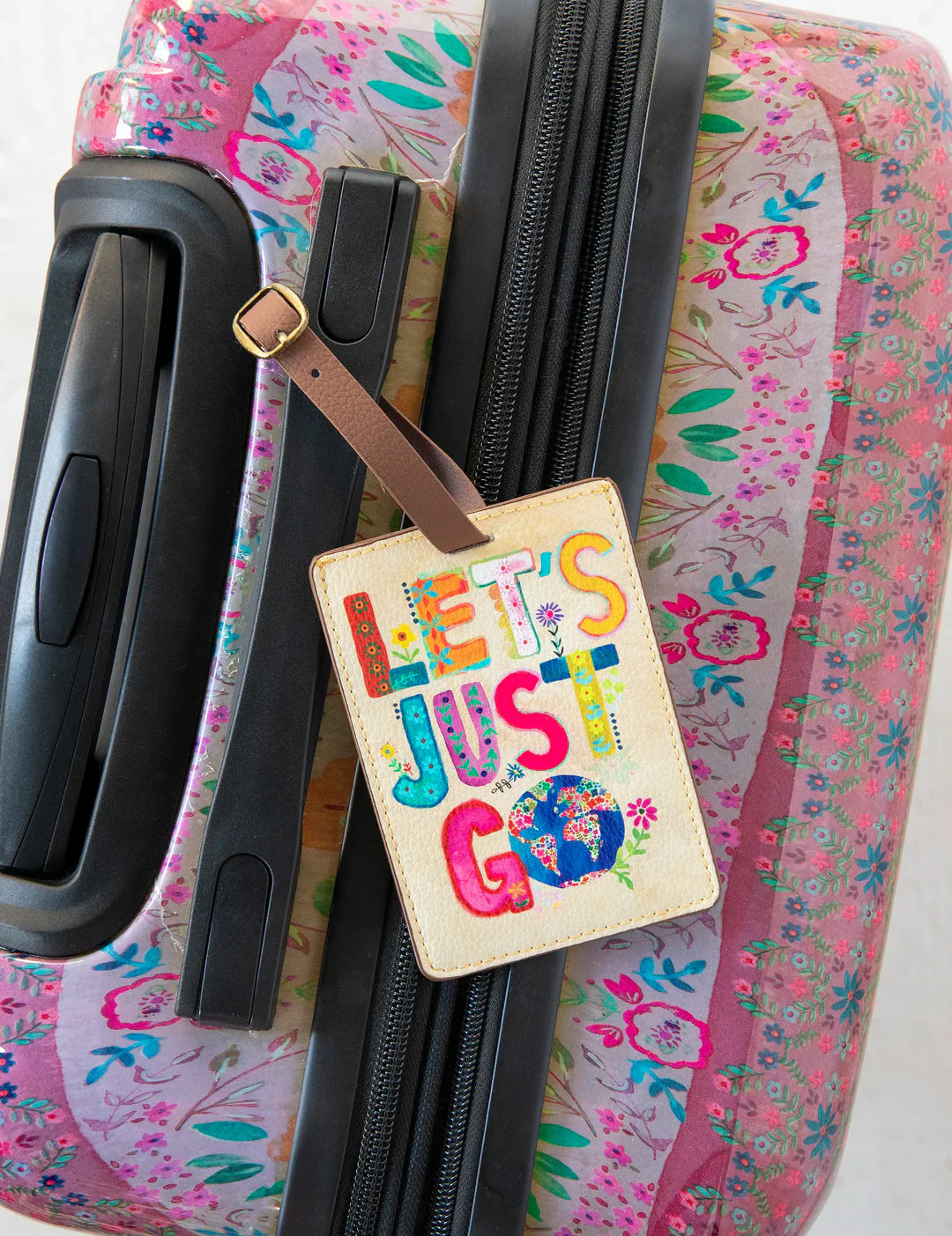 Vegan leather strap and buckle Natural Life luggage tag that reads "Let's Just Go."
