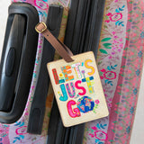 Vegan leather strap and buckle Natural Life luggage tag that reads "Let's Just Go."