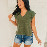 V-neck sleeveless green sweater vest with side slits.