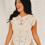 Round neck sleeveless crochet cutout top in natural.