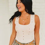 Scoop neck metal hole detail studded tank top in the color almond.
