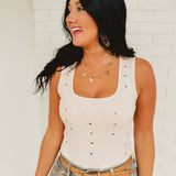 Scoop neck metal hole detail studded tank top in the color almond.