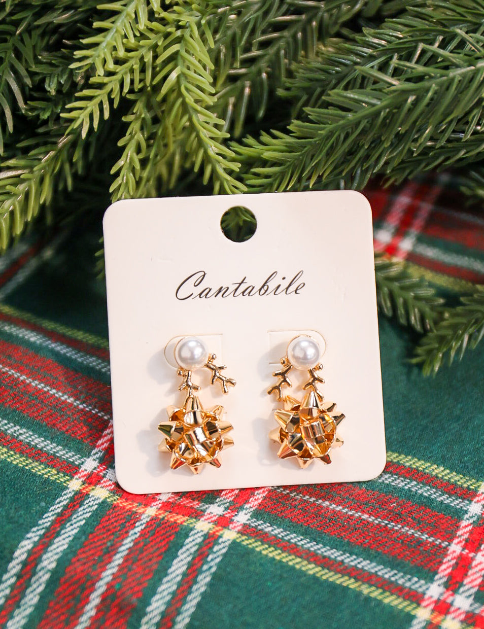 Set of 2 pearl reindeer and Christmas bow stud earrings in gold.