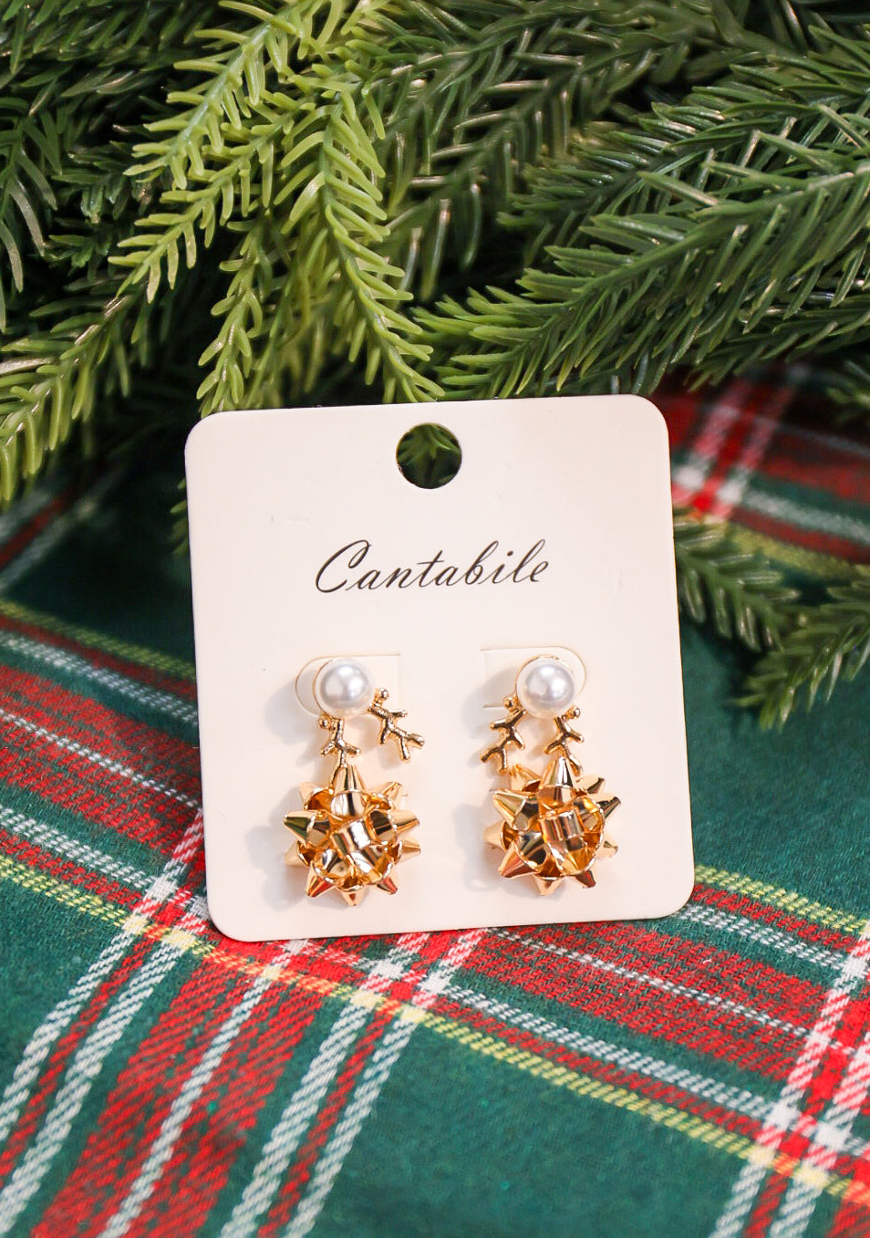 Set of 2 pearl reindeer and Christmas bow stud earrings in gold.