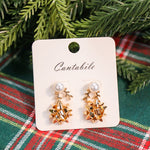 Set of 2 pearl reindeer and Christmas bow stud earrings in gold.