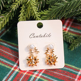 Set of 2 pearl reindeer and Christmas bow stud earrings in gold.