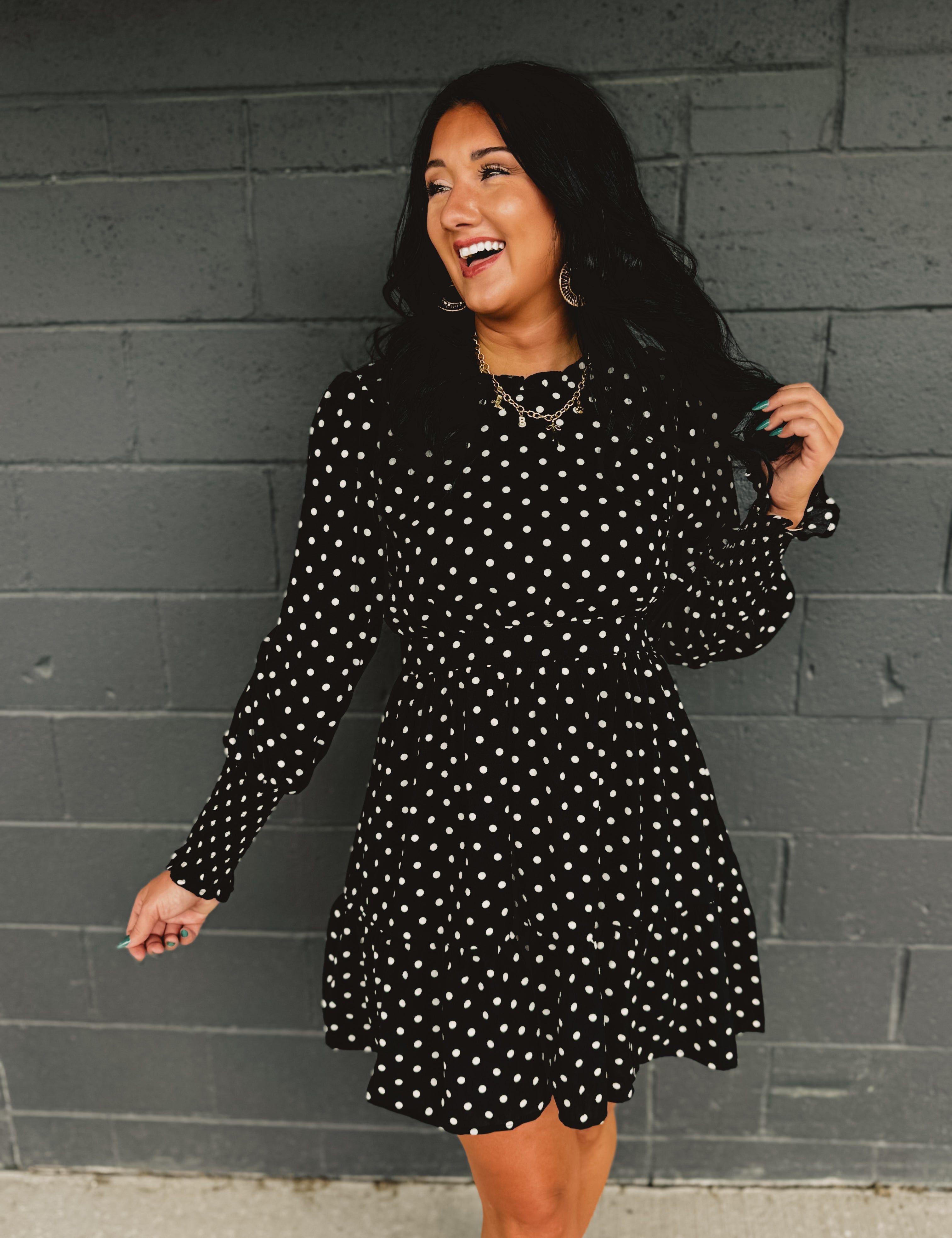 Polka dot ruffled mini dress with a mock neckline and long sleeves.