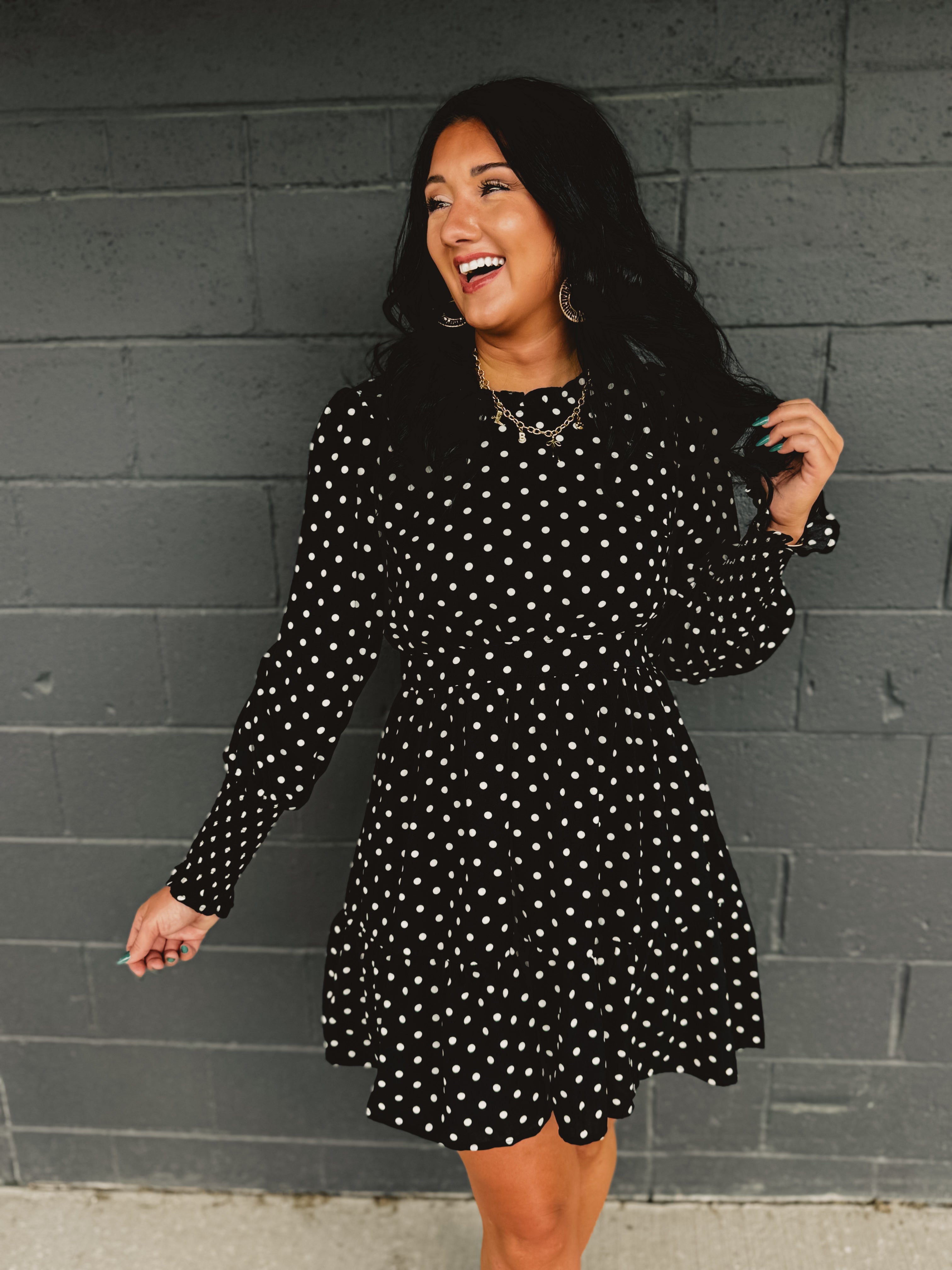 Polka dot ruffled mini dress with a mock neckline and long sleeves.
