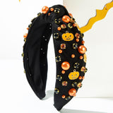 Pumpkin, pearl, and rhinestone studded knot headband.