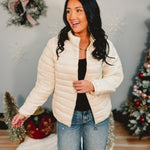 Quilted zip-up puffer jacket in off white.