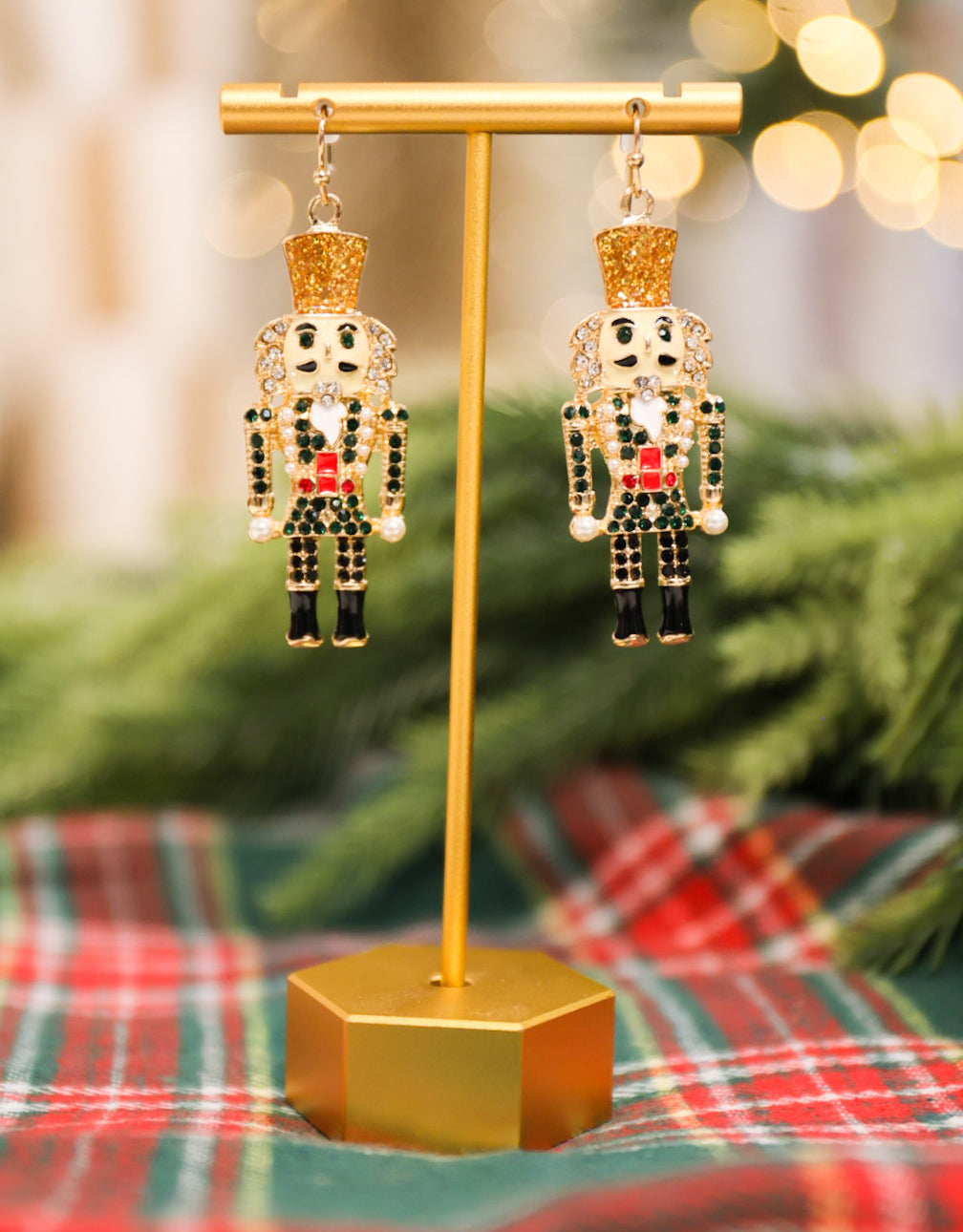 Rhinestone and pearl detail nutcracker drop earrings with glitter details.