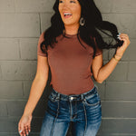 Short sleeved round neck ribbed fabric top in the color espresso.