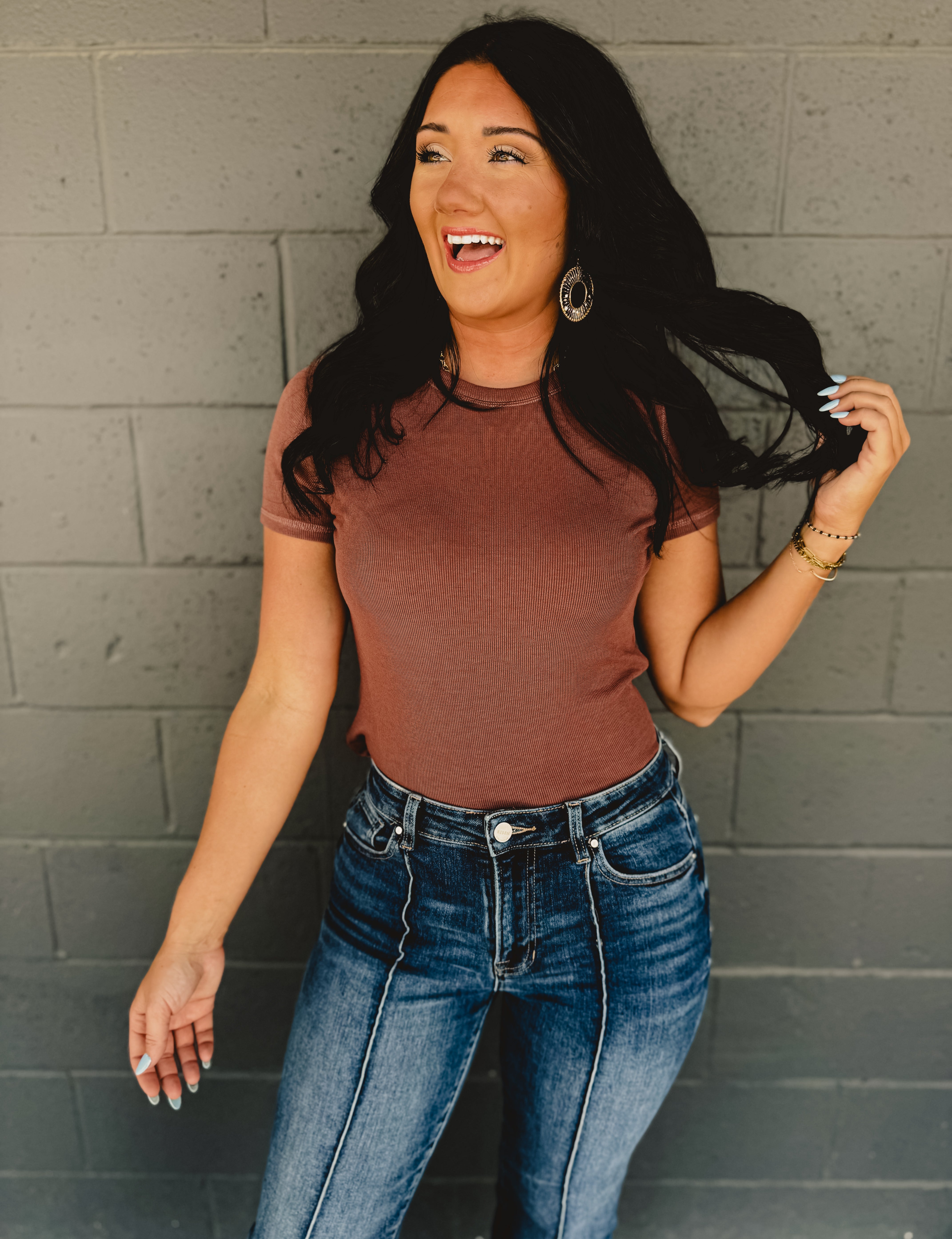 Short sleeved round neck ribbed fabric top in the color espresso.
